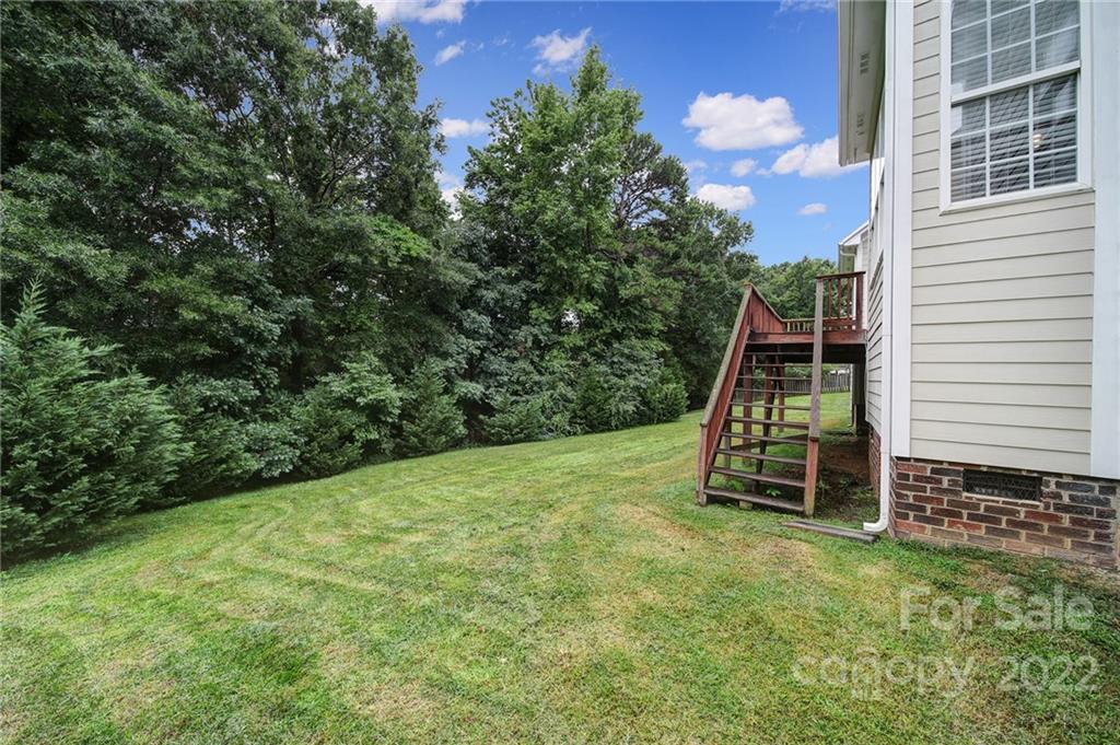 1711 Copperplate Road Charlotte, NC 28262 - Photo 40 of 48 a view of a backyard with plants and a slide