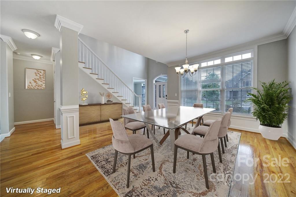 1711 Copperplate Road Charlotte, NC 28262 - Photo 6 of 48 a dining room with furniture a chandelier and wooden floor