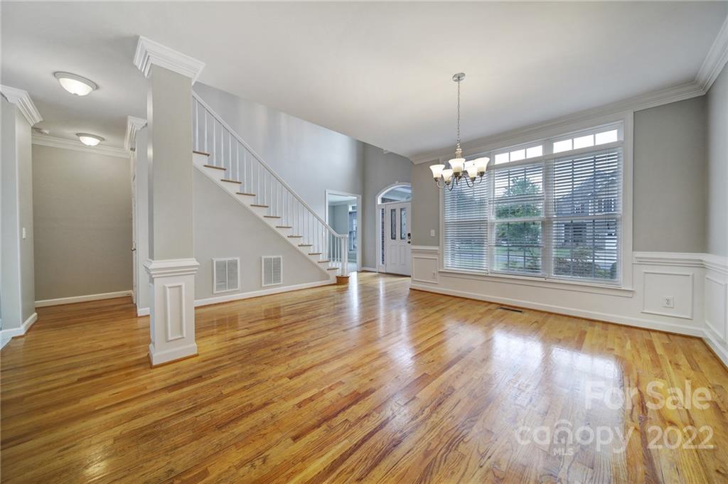 1711 Copperplate Road Charlotte, NC 28262 - Photo 7 of 48 a view of a room with wooden floor potted plant and windows