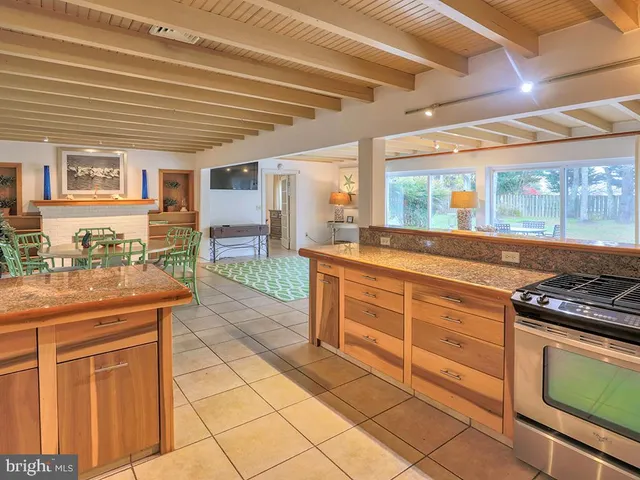 a kitchen with stainless steel appliances granite countertop a stove and a sink