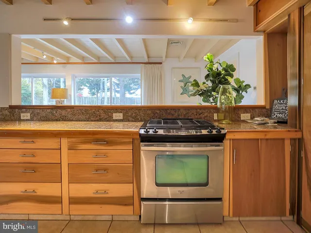 a stove top oven sitting inside of a kitchen