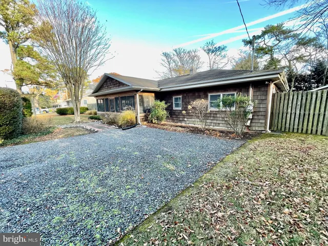 a view of a house with a yard and roof
