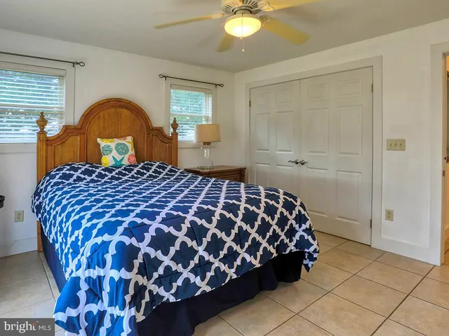 a spacious bedroom with a bed and a chandelier