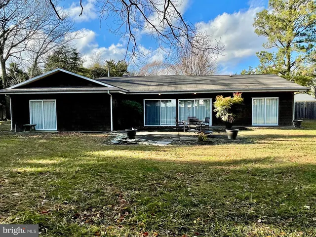 an aerial view of a house with a yard and garden
