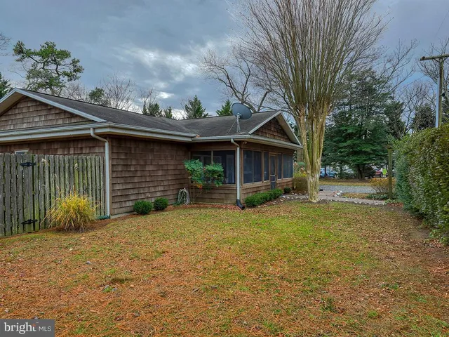 a front view of house with yard seating and green space