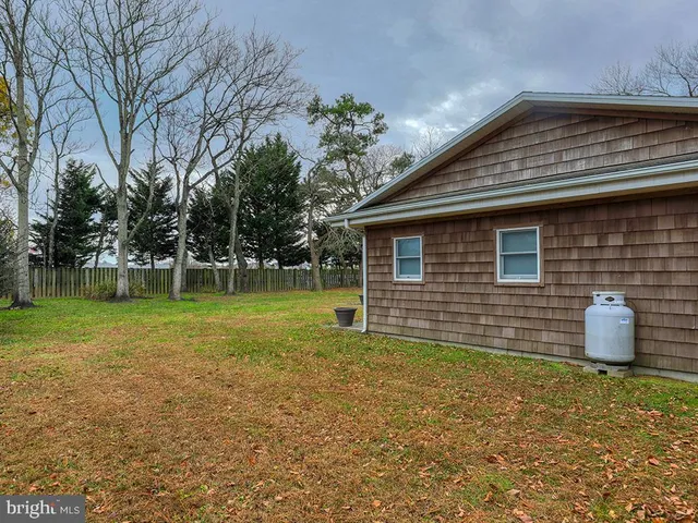 a backyard of a house with yard and outdoor seating