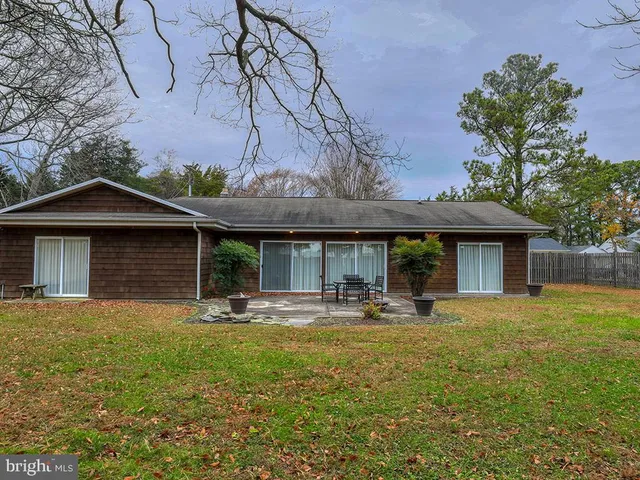 a view of a house with pool and a yard