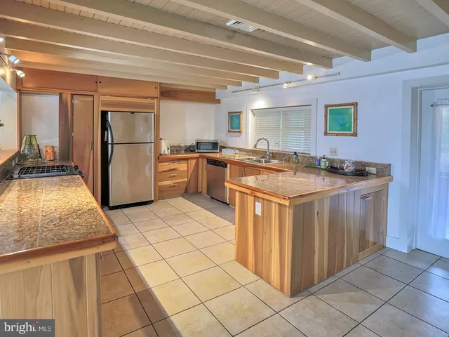 a kitchen with a stove sink and refrigerator