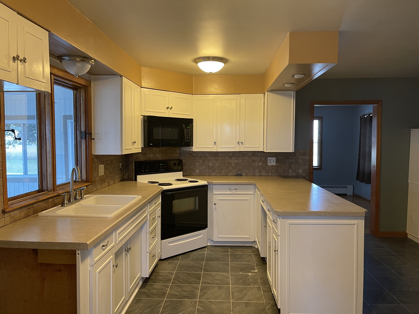 18221 Fairhaven Road Chadwick, IL 61014 - Photo 3 of 20 a kitchen with a sink a stove top oven and cabinetry