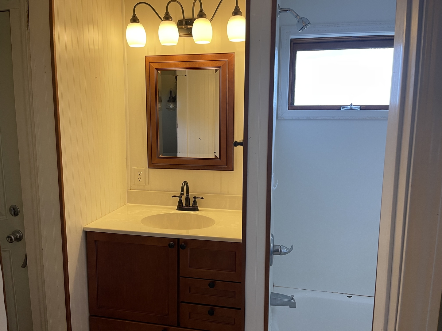 18221 Fairhaven Road Chadwick, IL 61014 - Photo 4 of 20 a bathroom with a sink a mirror and a bathtub