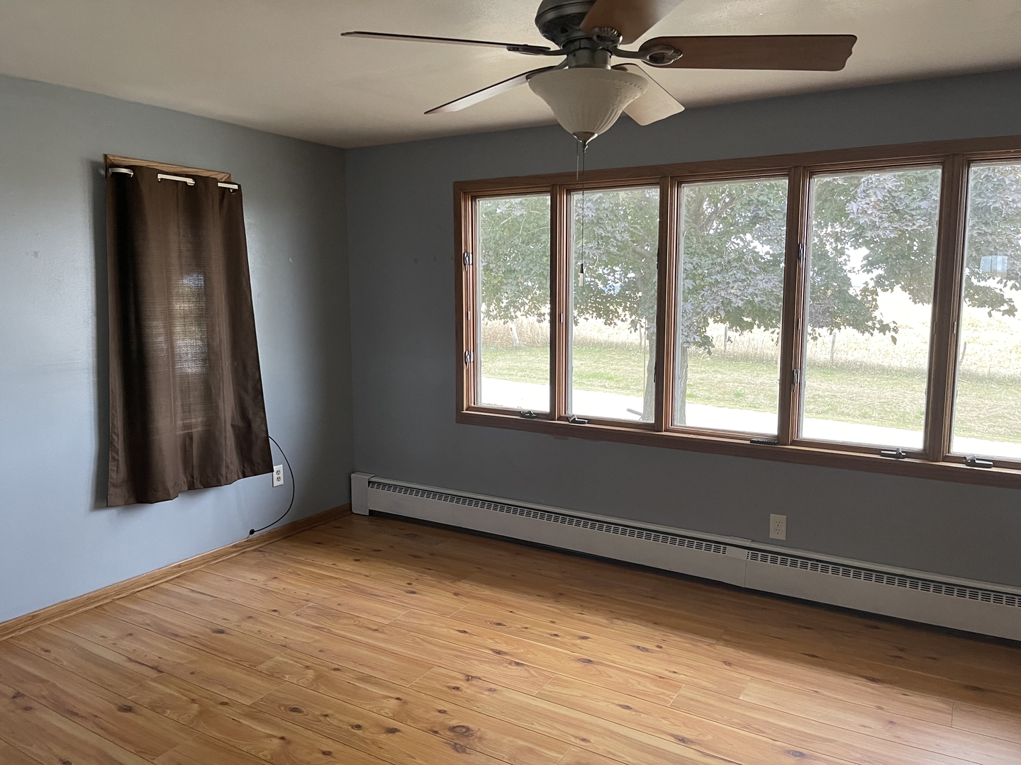 18221 Fairhaven Road Chadwick, IL 61014 - Photo 6 of 20 a view of an empty room with wooden floor and a window