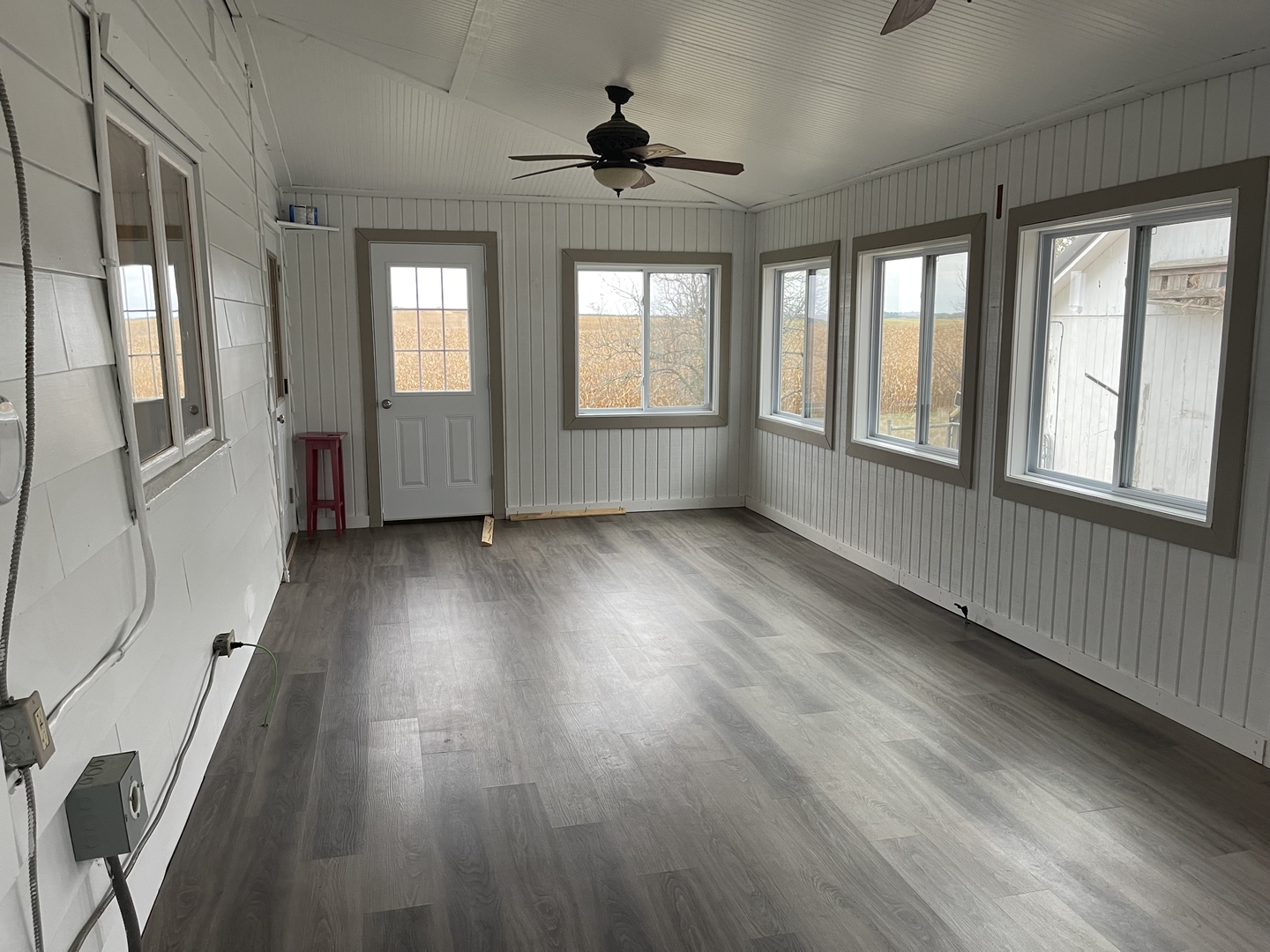 18221 Fairhaven Road Chadwick, IL 61014 - Photo 7 of 20 a view of an empty room with wooden floor and a window
