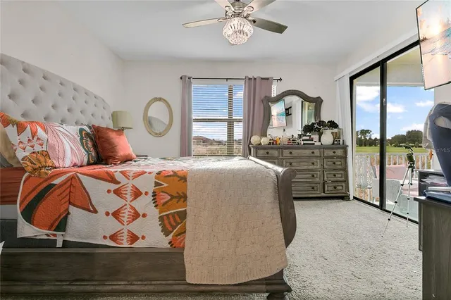 a bedroom with a large bed and a chandelier