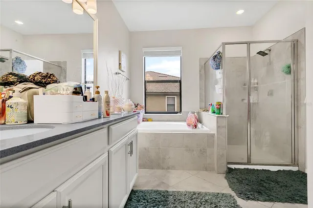 a bathroom with a tub sink and mirror