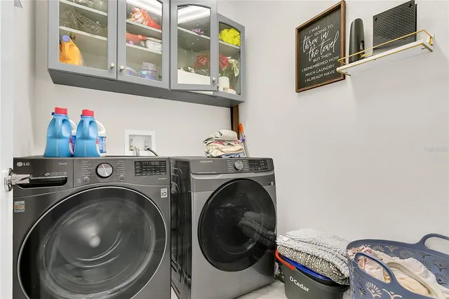 a utility room with dryer washer and a window