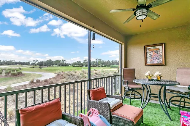 a balcony with couple of chairs and a swing