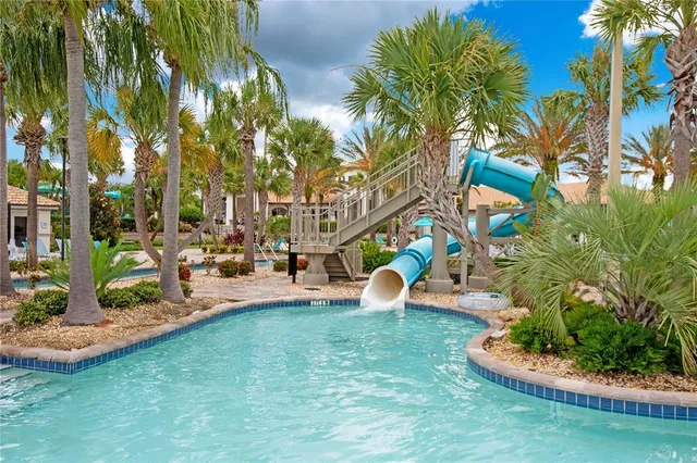 a view of a white house with a yard and potted plants