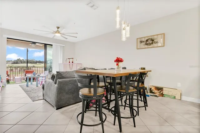 a dining room with furniture and window