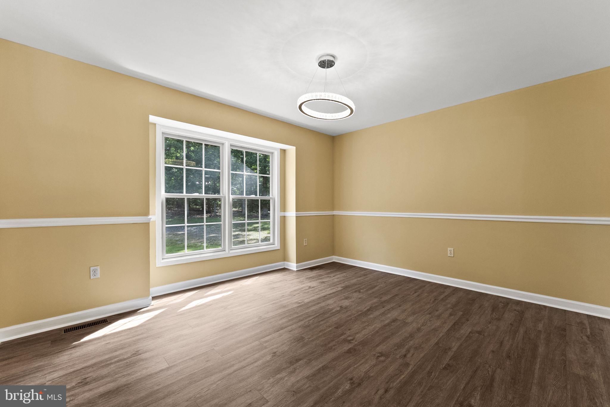 20065 Crooked Run Road Culpeper, VA 22701 - Photo 11 of 62 a view of an empty room with wooden floor and a window