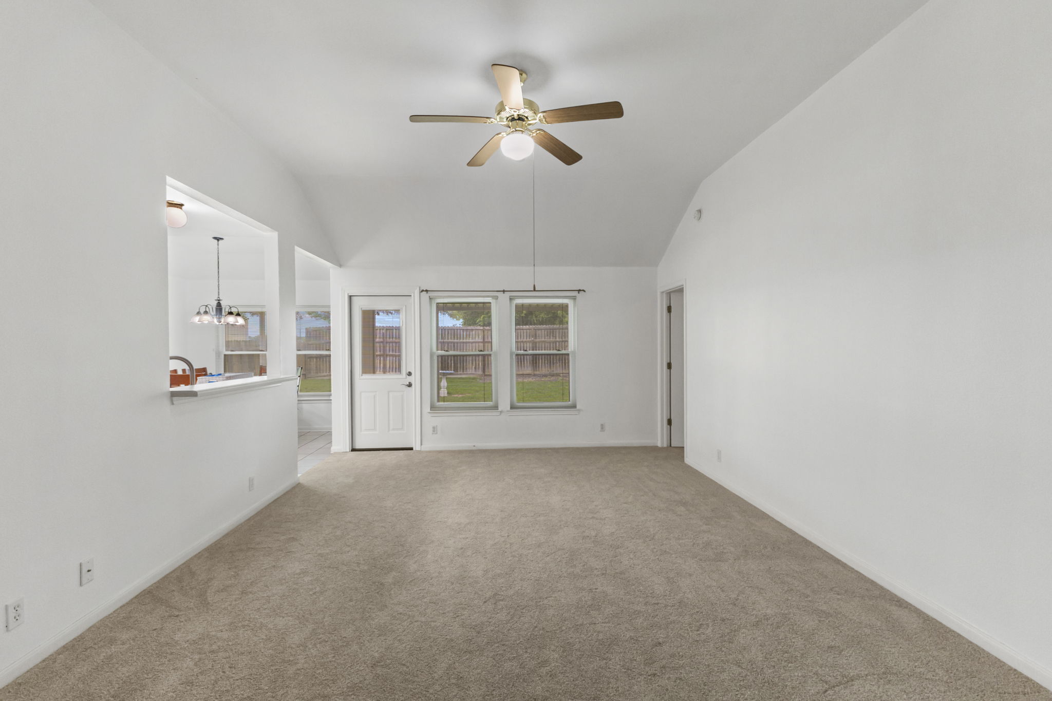 290 Bailey Loop Kyle, TX 78640 - Photo 12 of 33 Carpeted living space featuring a vaulted ceiling and a ceiling fan