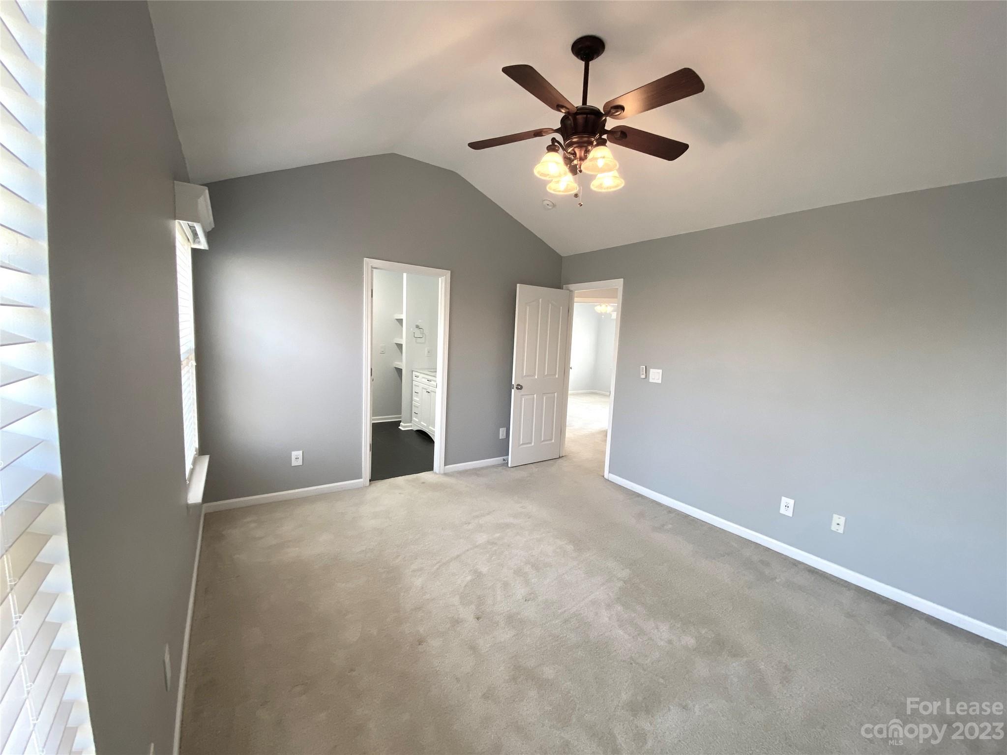 161 Mott Road Mooresville, NC 28115 - Photo 14 of 27 an empty room with chandelier fan and windows