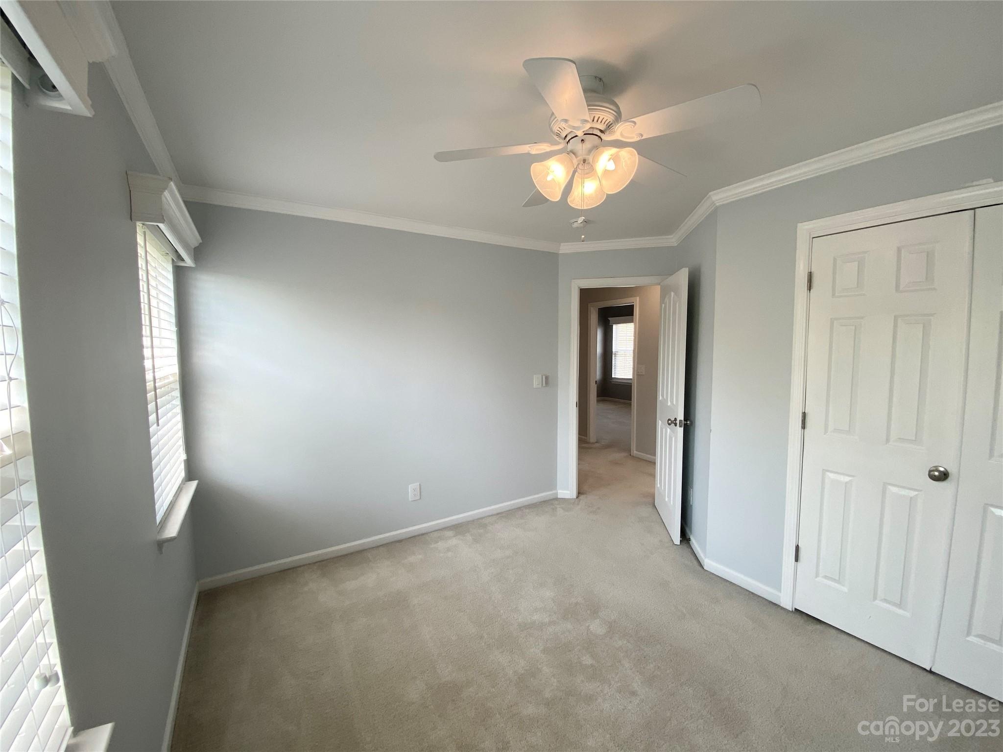 161 Mott Road Mooresville, NC 28115 - Photo 21 of 27 a view of an empty room with a chandelier fan