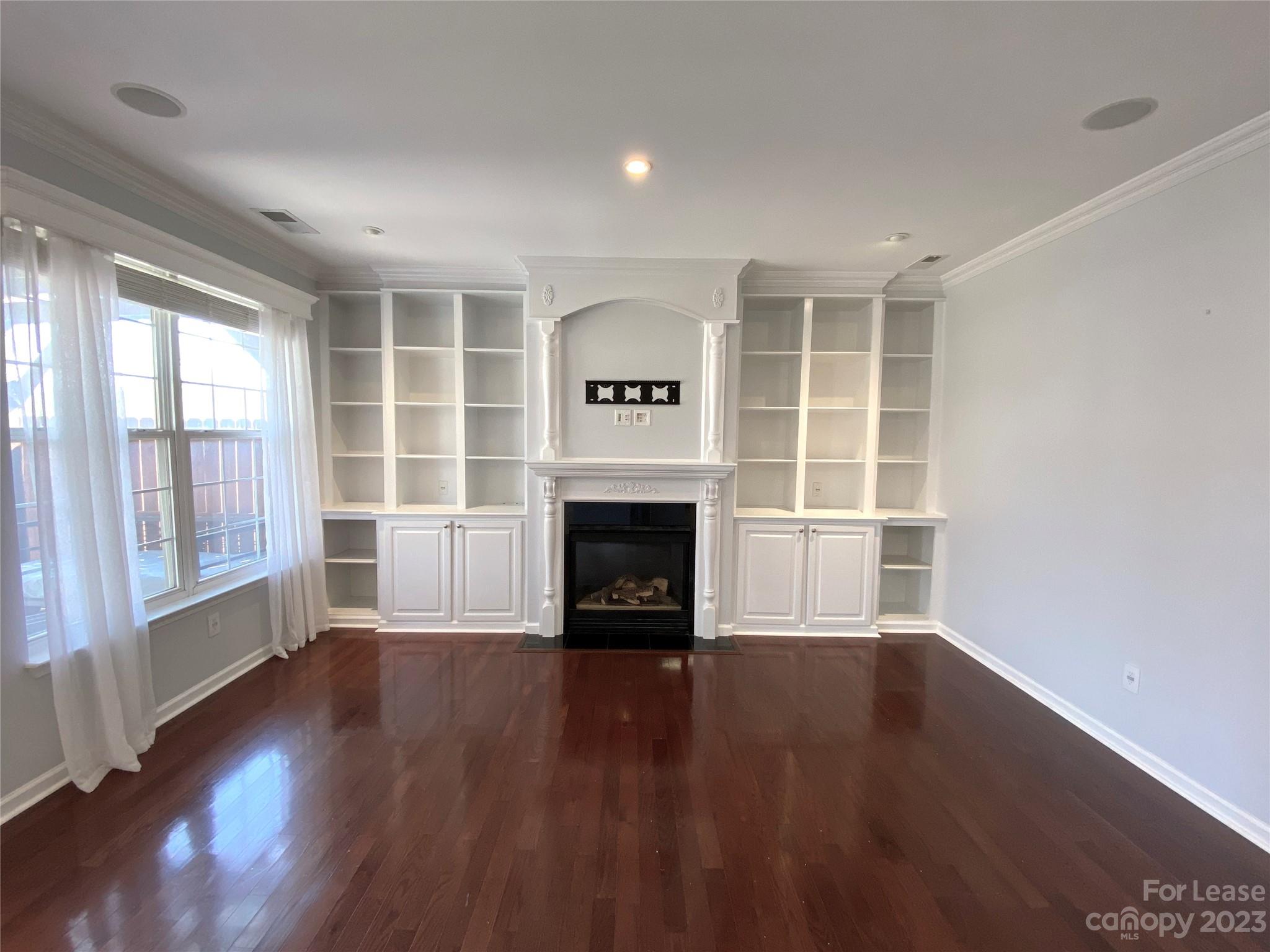 161 Mott Road Mooresville, NC 28115 - Photo 6 of 27 wooden floor fireplace and windows in an empty room