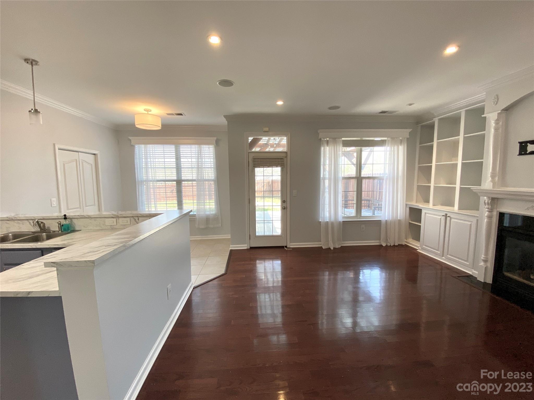 161 Mott Road Mooresville, NC 28115 - Photo 8 of 27 a view of an empty room with a window and wooden floor