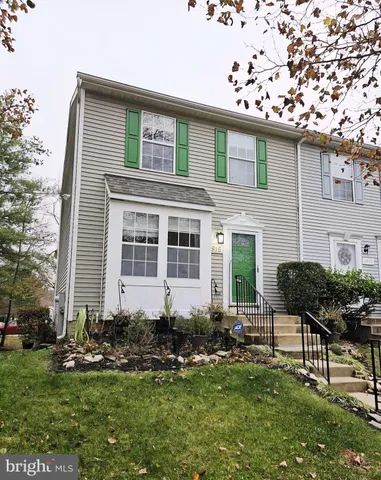a front view of a house with garden and porch
