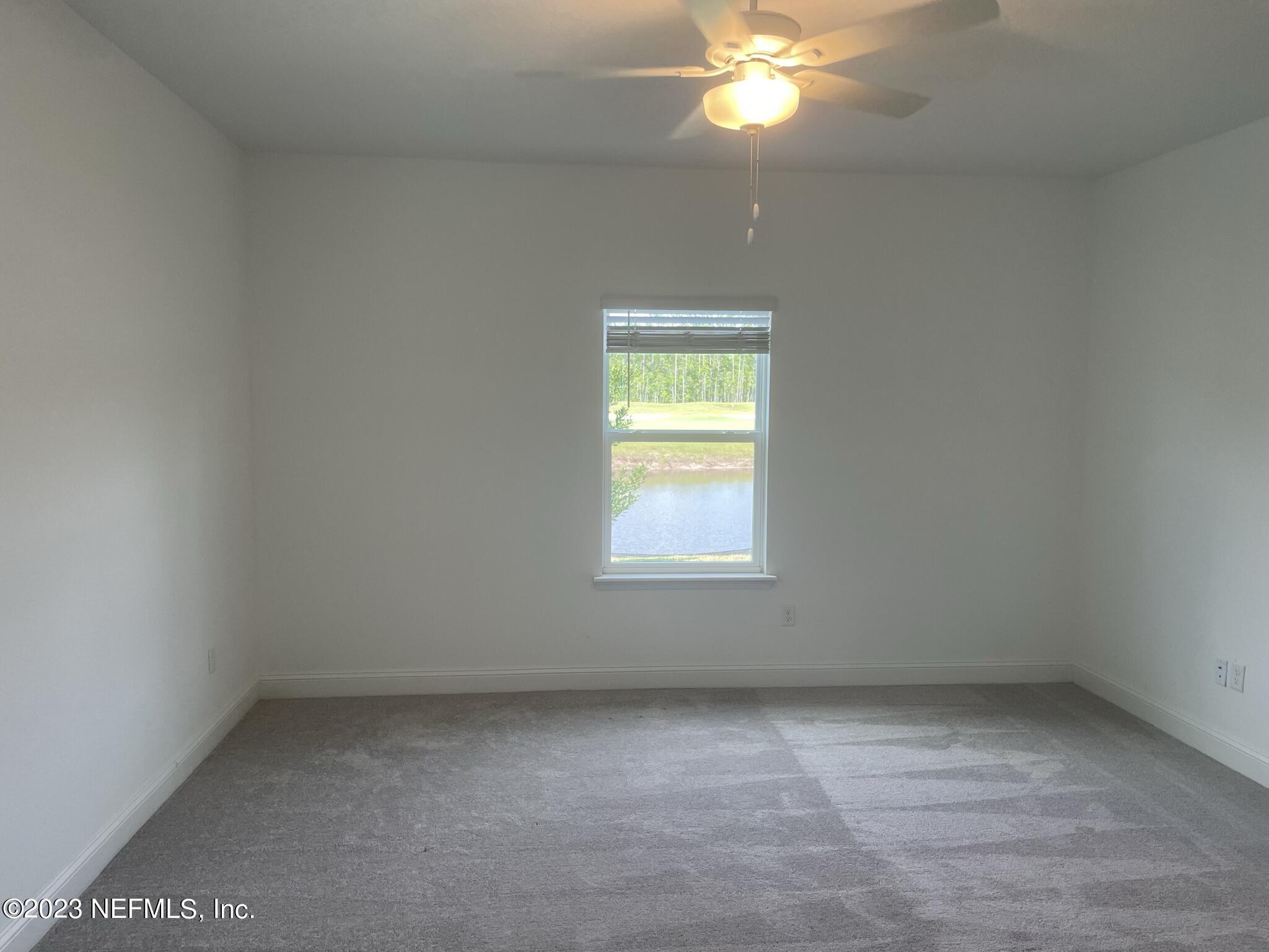 35 Hammer Circle St. Johns, FL 32259 - Photo 12 of 22 an empty room with a chandelier fan and windows
