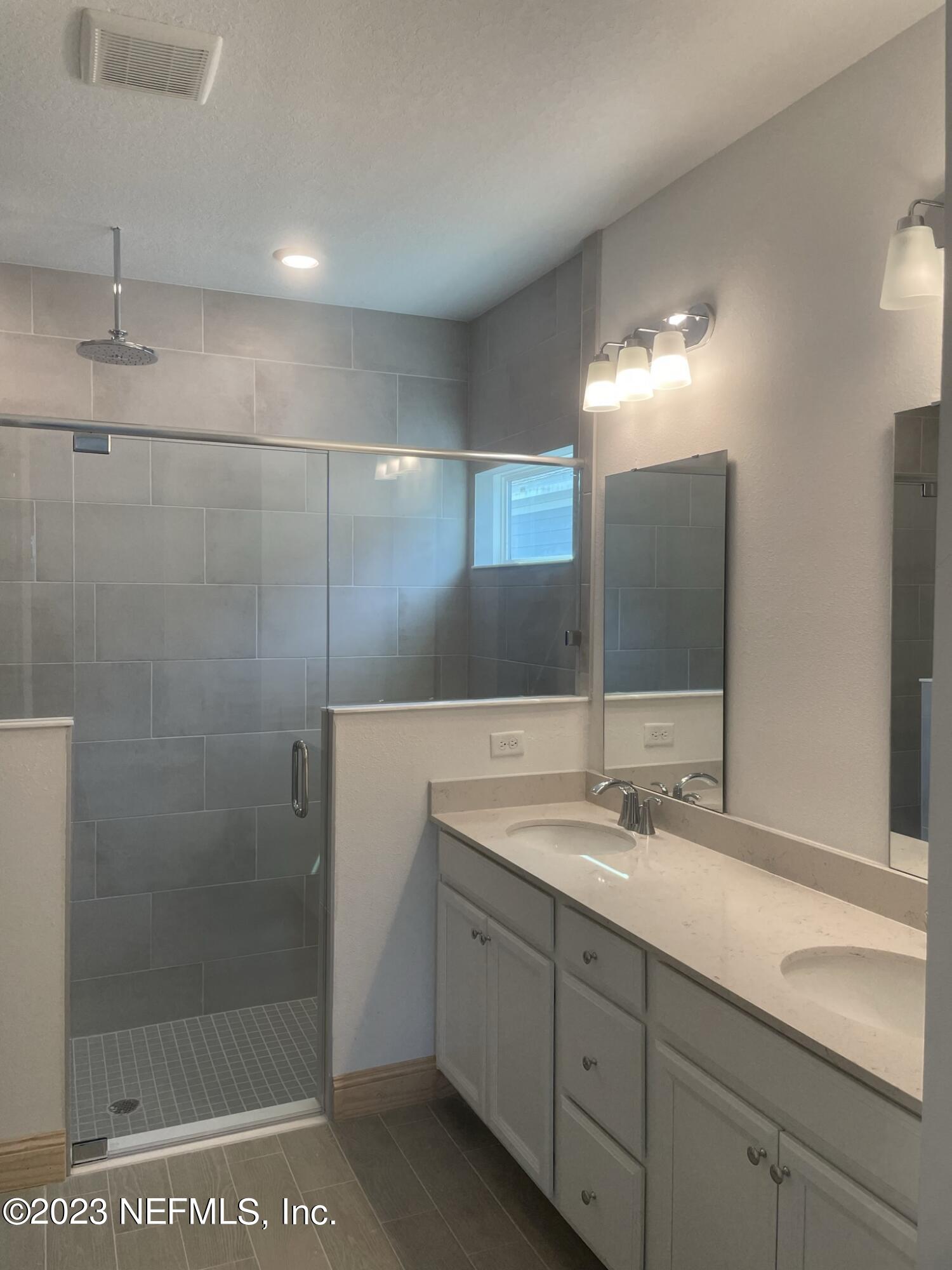 35 Hammer Circle St. Johns, FL 32259 - Photo 13 of 22 a bathroom with a shower sink and mirror