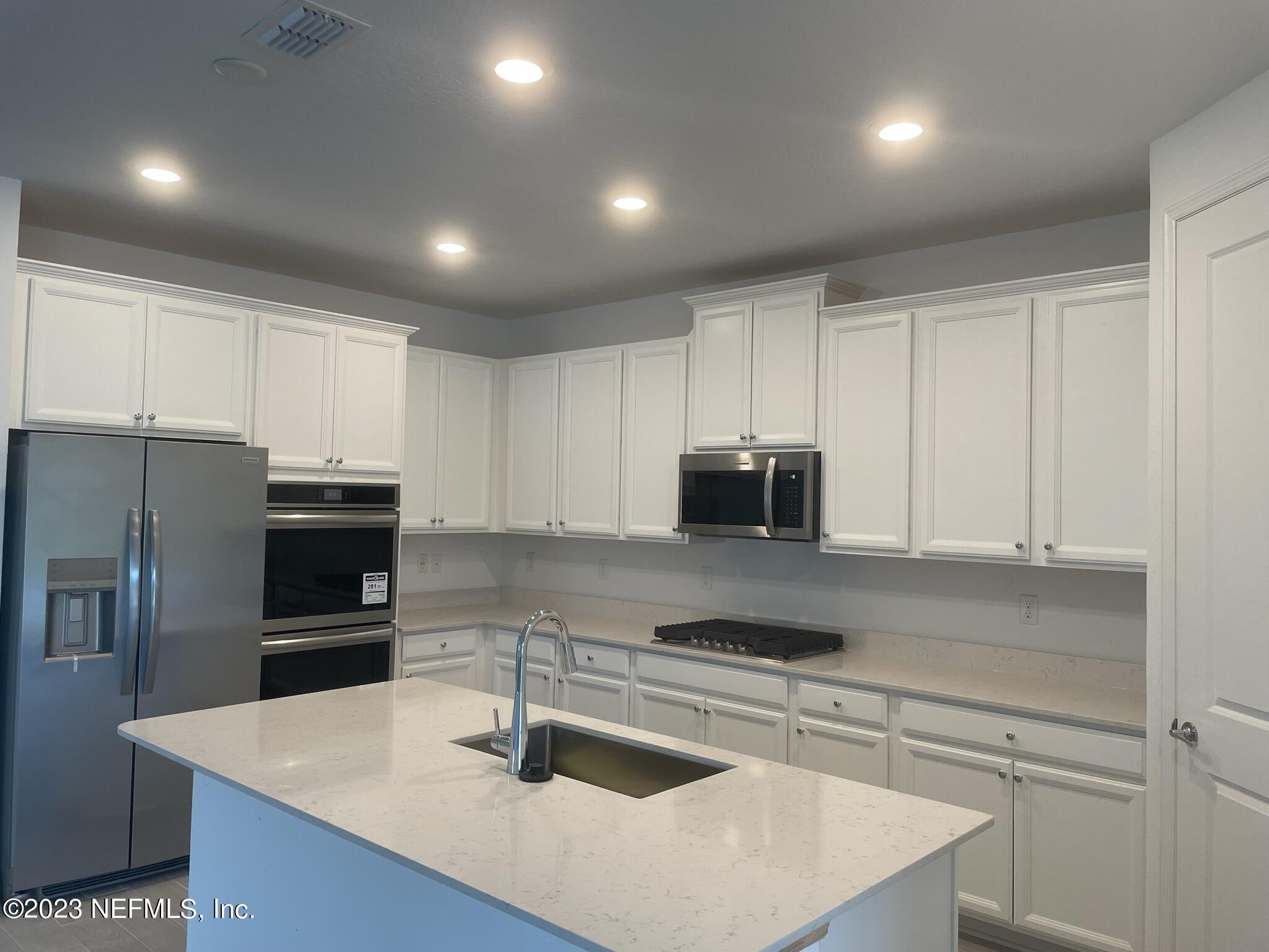 35 Hammer Circle St. Johns, FL 32259 - Photo 4 of 22 a kitchen with kitchen island a sink stainless steel appliances and cabinets