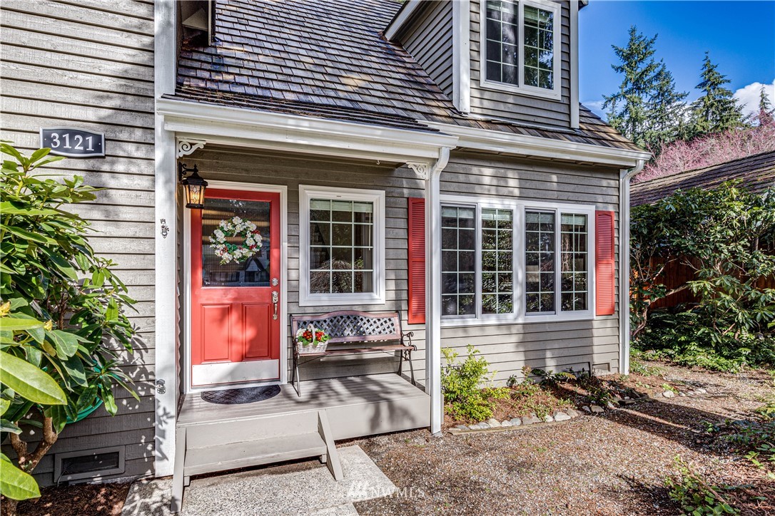 3121 166th Place Southeast Bothell, WA 98012 - Photo 2 of 28 front view of house with a chair and table and chair and wooden fence