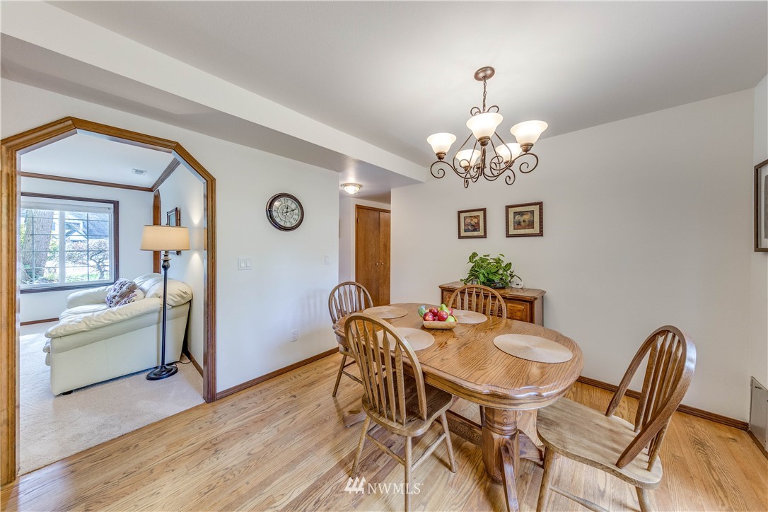 3121 166th Place Southeast Bothell, WA 98012 - Photo 11 of 28 a view of a dining room with furniture and wooden floor