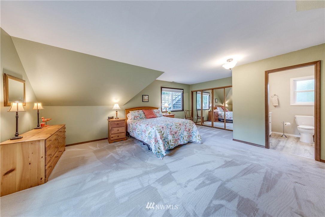 3121 166th Place Southeast Bothell, WA 98012 - Photo 20 of 28 a spacious bedroom with a bed and a cabinets