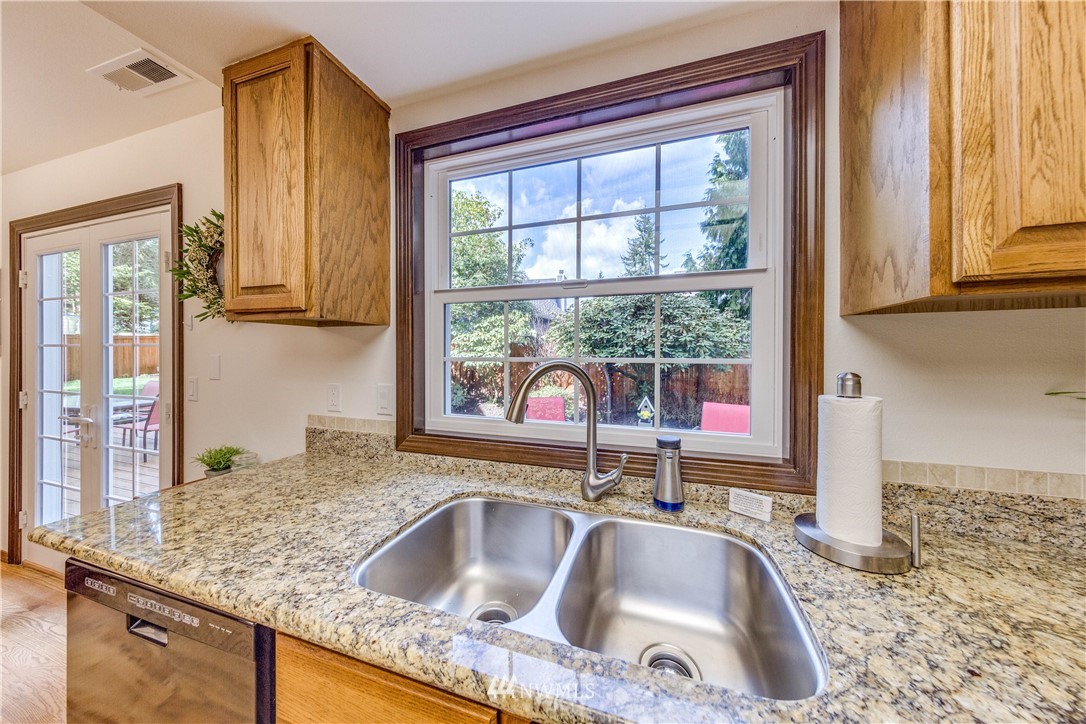 3121 166th Place Southeast Bothell, WA 98012 - Photo 10 of 28 a kitchen with granite countertop a sink and a window
