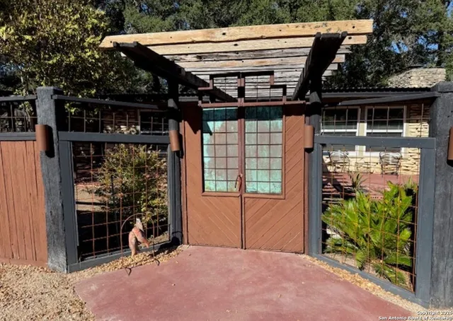 a view of a porch with a table and chairs