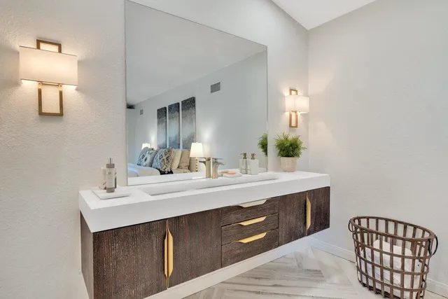 a spacious bathroom with a sink and a mirror