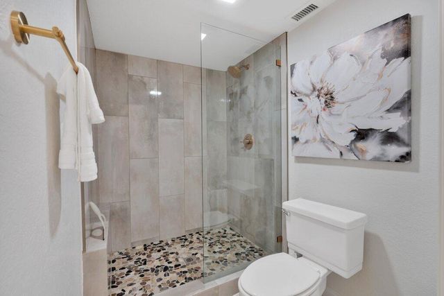 a white toilet sitting next to a bathroom sink