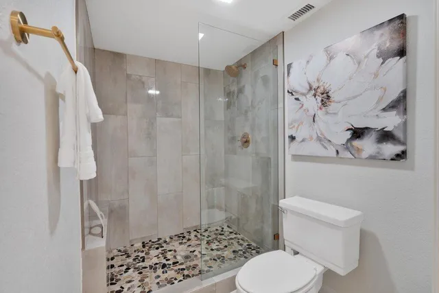 a white toilet sitting next to a bathroom sink