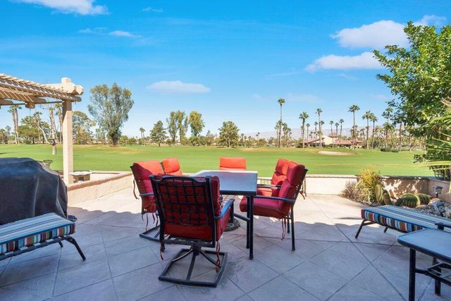 a view of a chairs and table in the patio