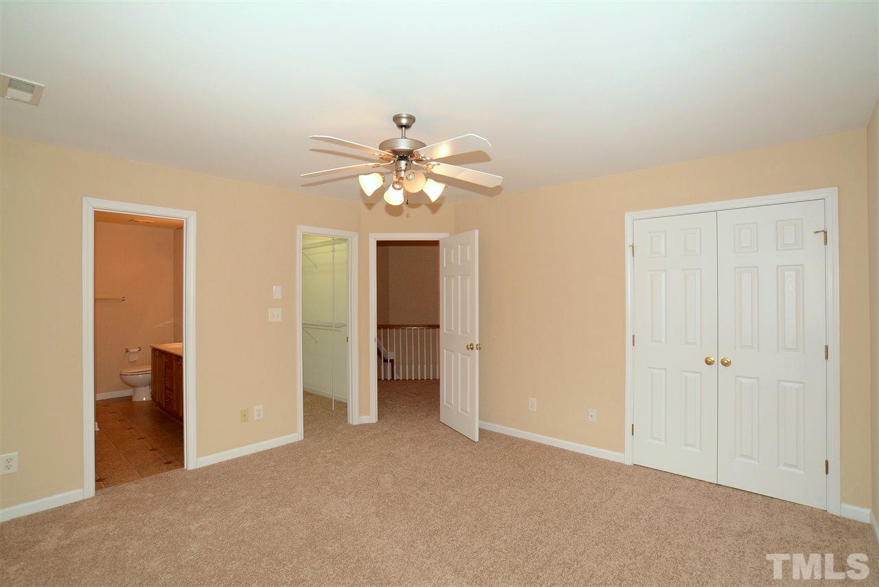 4604 Marathon Lane Raleigh, NC 27616 - Photo 15 of 25 an empty room with chandelier fan and closet area