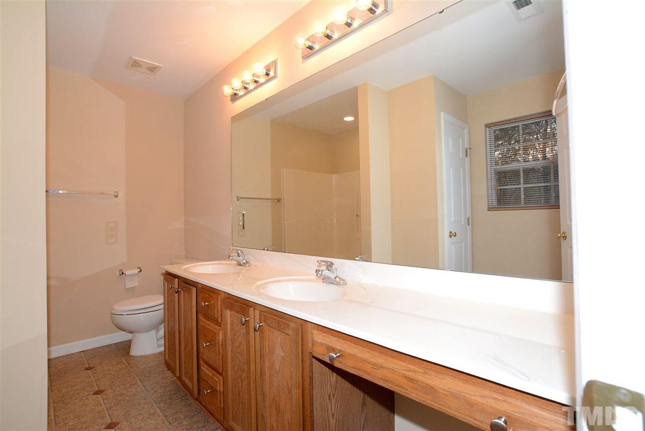 4604 Marathon Lane Raleigh, NC 27616 - Photo 16 of 25 a bathroom with a sink a toilet and shower