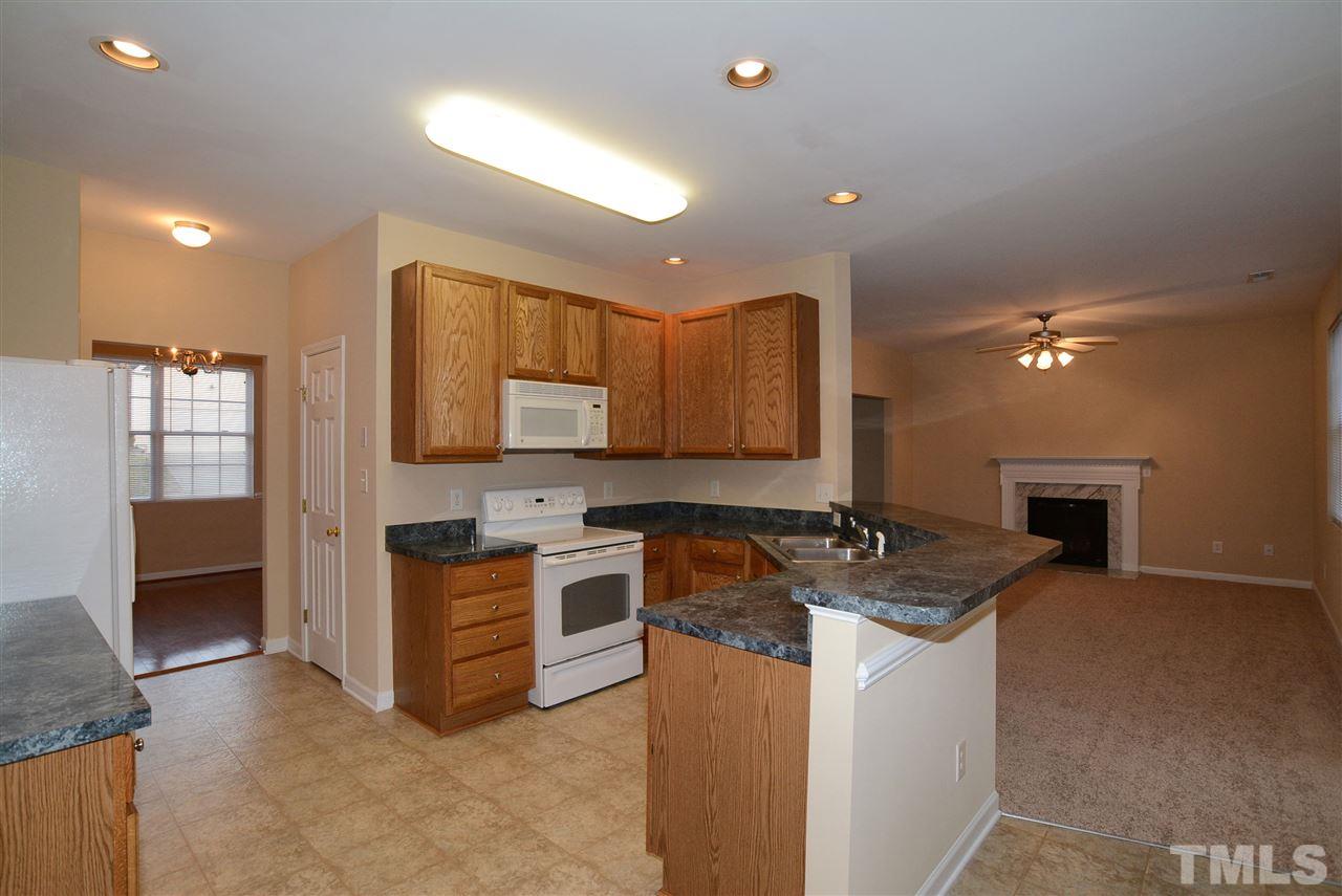 4604 Marathon Lane Raleigh, NC 27616 - Photo 9 of 25 a kitchen with stainless steel appliances granite countertop a stove a sink and a microwave