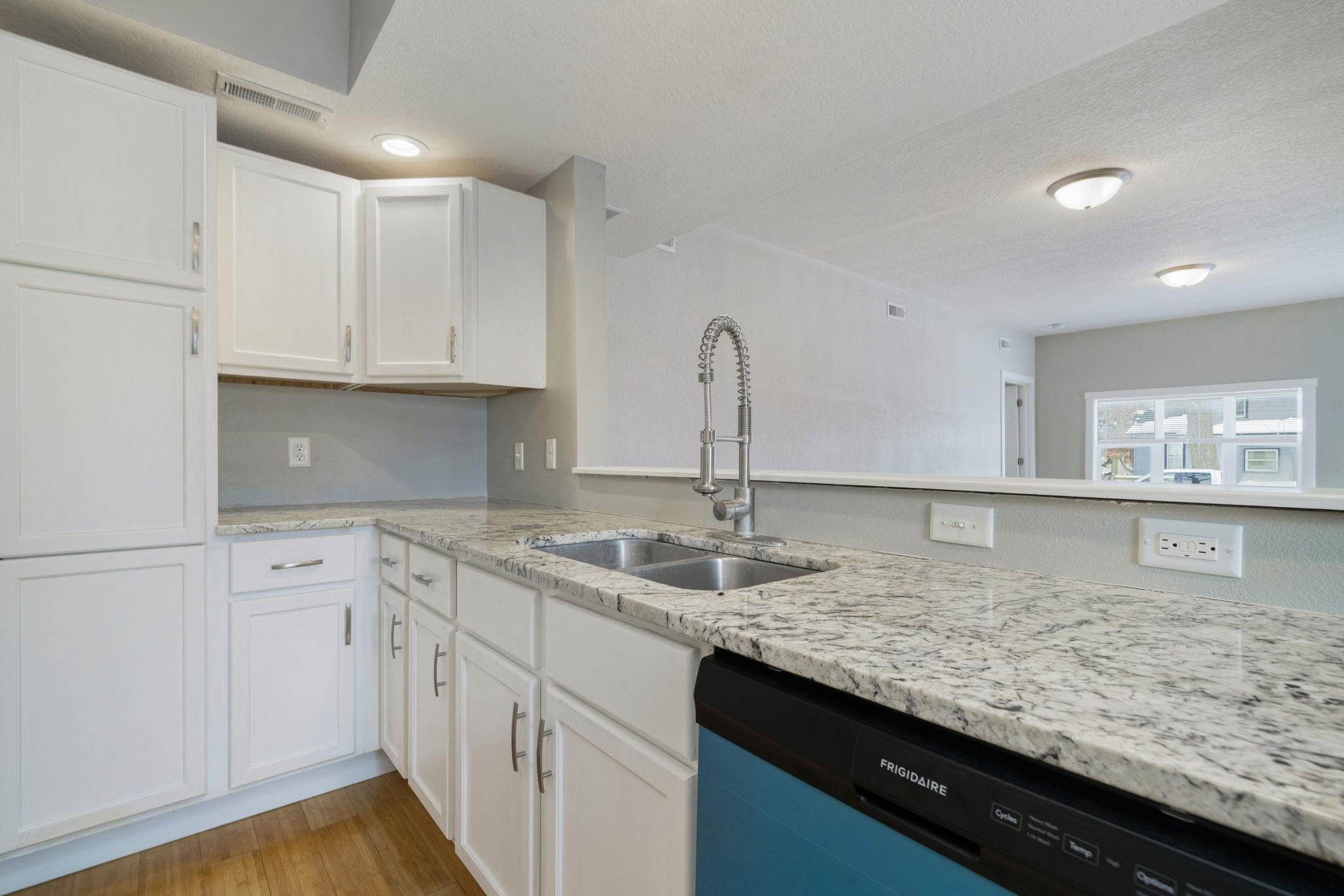 1104 South 4th Street Oregon, IL 61061 - Photo 15 of 36 a kitchen with granite countertop a sink a stove and cabinets