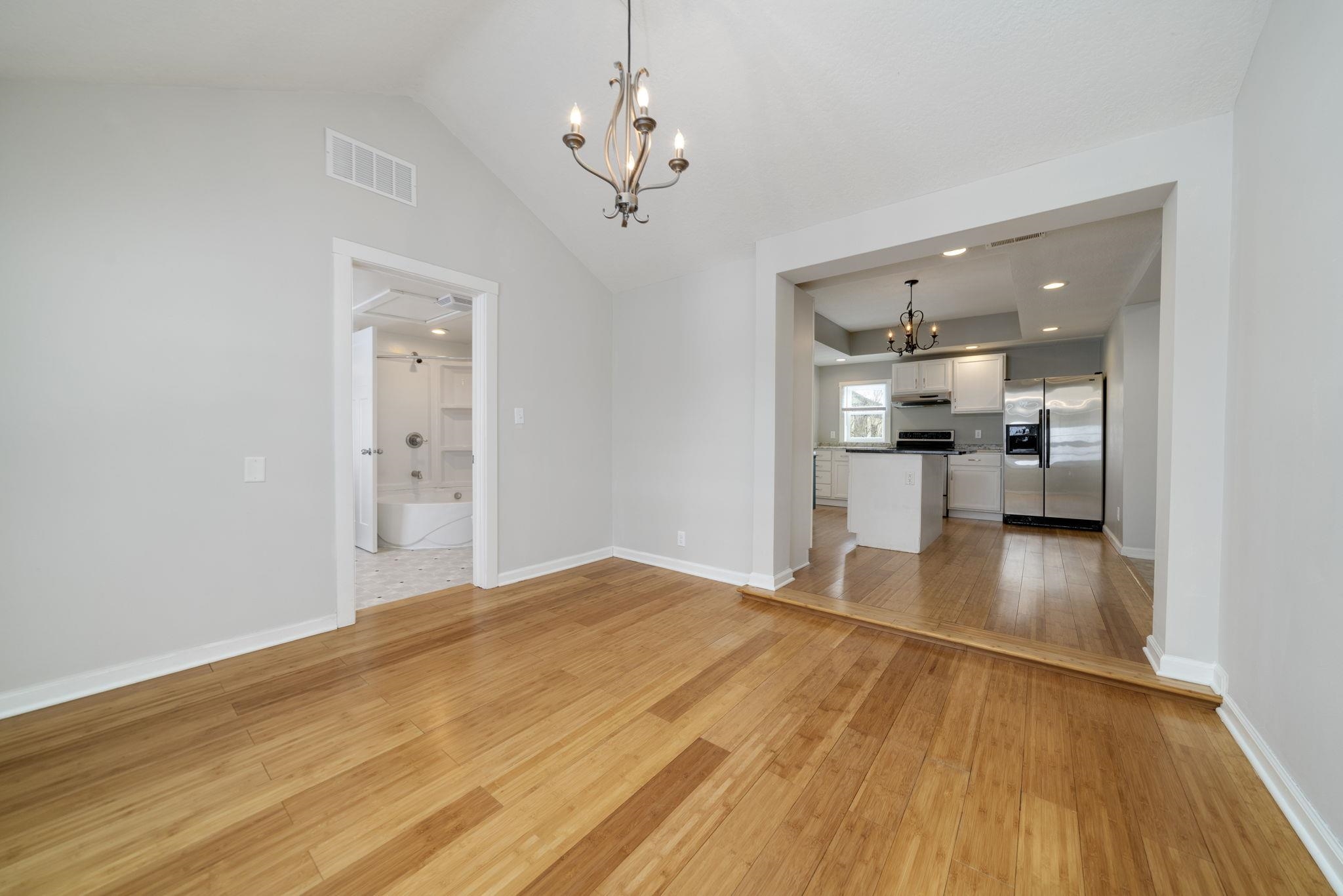 1104 South 4th Street Oregon, IL 61061 - Photo 19 of 36 a view of a livingroom with furniture wooden floor and a kitchen