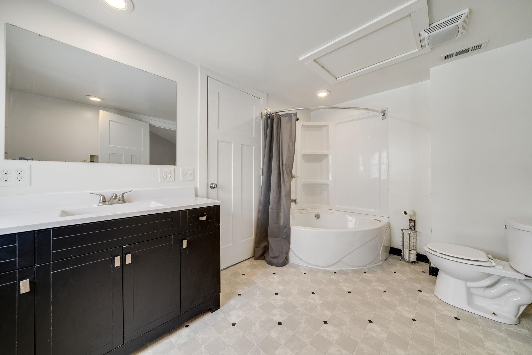 1104 South 4th Street Oregon, IL 61061 - Photo 20 of 36 a bathroom with a sink toilet double vanity and bathtub