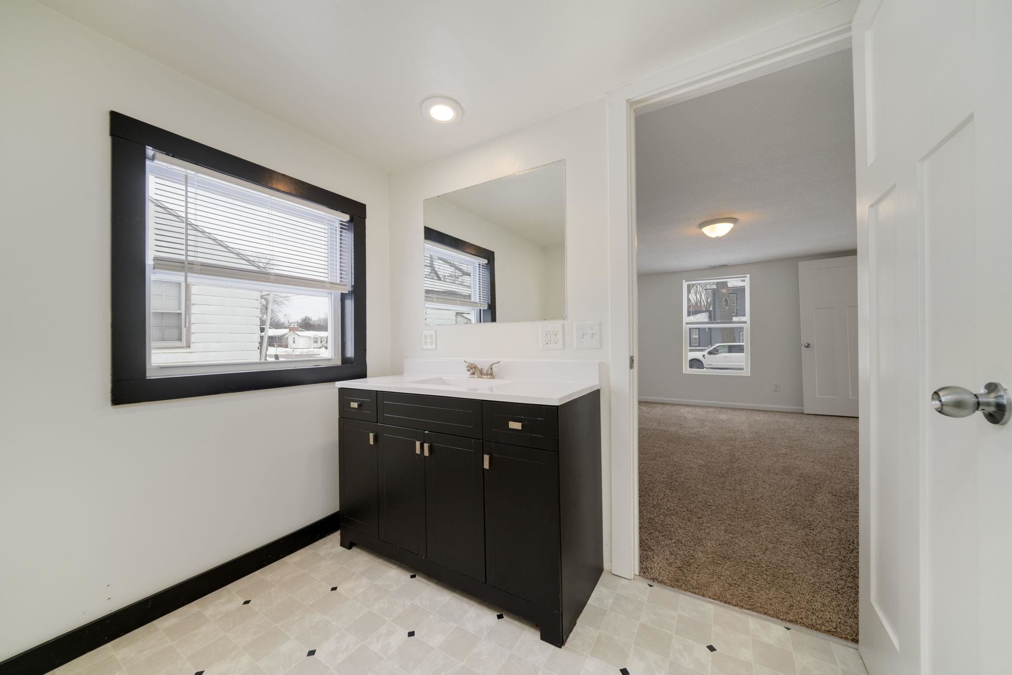 1104 South 4th Street Oregon, IL 61061 - Photo 5 of 36 a bathroom with a sink mirror and vanity