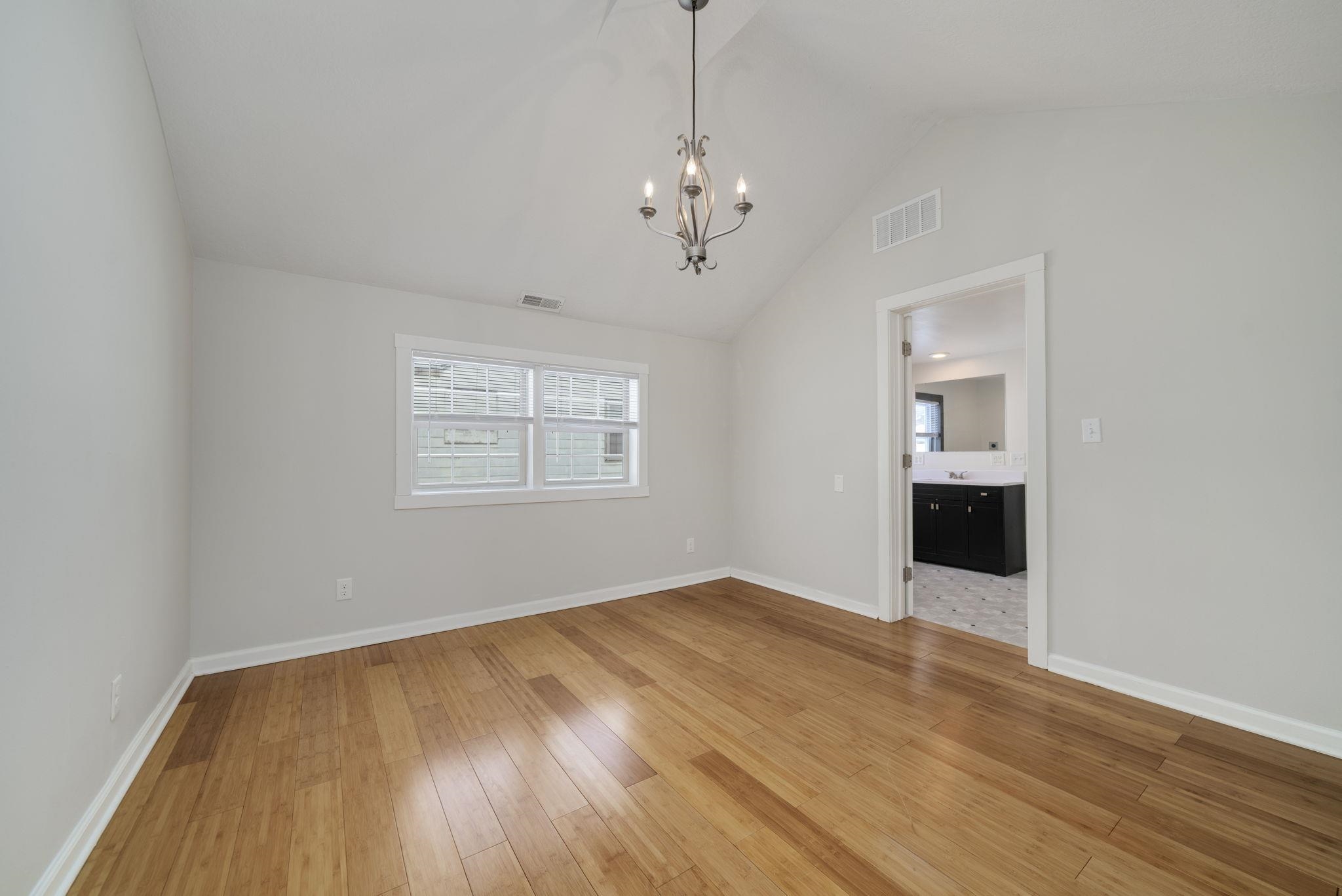 1104 South 4th Street Oregon, IL 61061 - Photo 6 of 36 a view of an empty room with wooden floor and a window