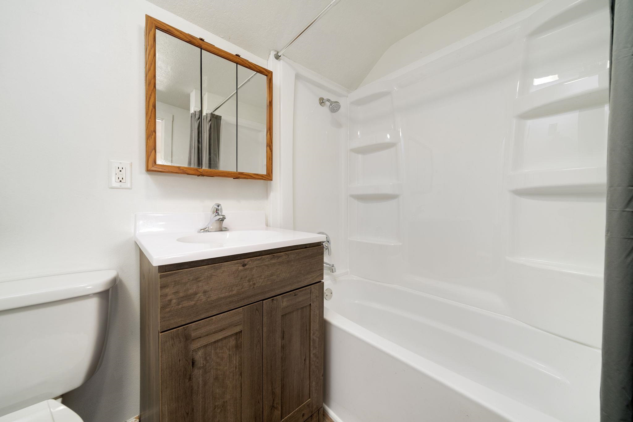 1104 South 4th Street Oregon, IL 61061 - Photo 8 of 36 a bathroom with a shower sink vanity mirror and toilet